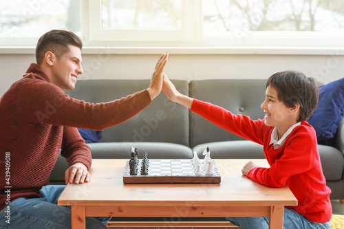 Father and son playing ches...