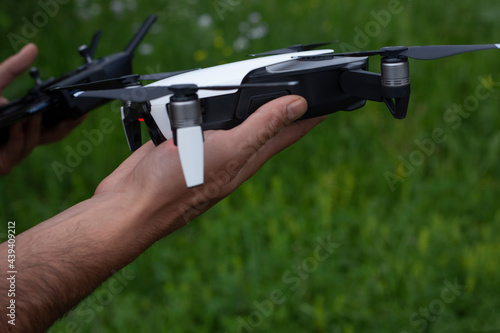 man controls the drone using the remote control. Close-up photo.