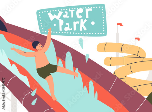 Kid in water park happy sliding to swimming pool from waterslide. Cheerful boy splash in aqua park