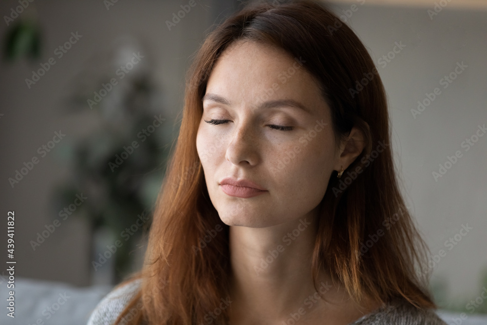Head shot portrait close up of calm beautiful woman with closed eyes meditating, peaceful mindful young female dreaming, visualizing future, new opportunities or taking nap at home alone, no stress Head shot portrait close up of calm beautiful woman with closed eyes meditating, peaceful mindful young female dreaming, visualizing future, new opportunities or taking nap at home alone, no stress