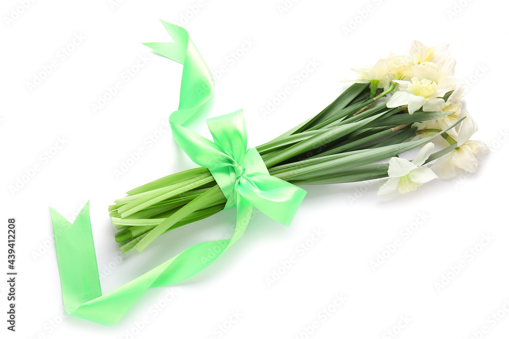 Fototapeta premium Beautiful daffodils and ribbon on white background