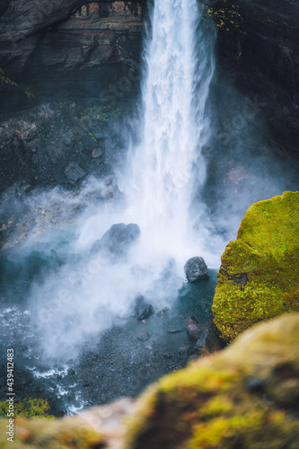 Close up of Haifoss waterfall in South Iceland. Water is crashing against the rocks on the bottom and splashing around. Defocused foreground