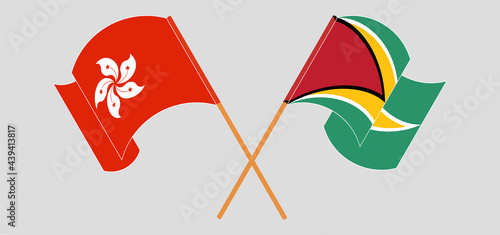 Crossed and waving flags of Hong Kong and Guyana