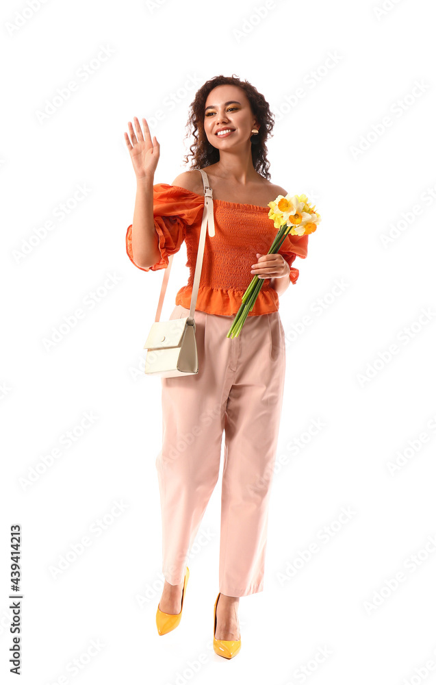 Beautiful young African-American woman with narcissus bouquet on white background Beautiful young African-American woman with narcissus bouquet on white background