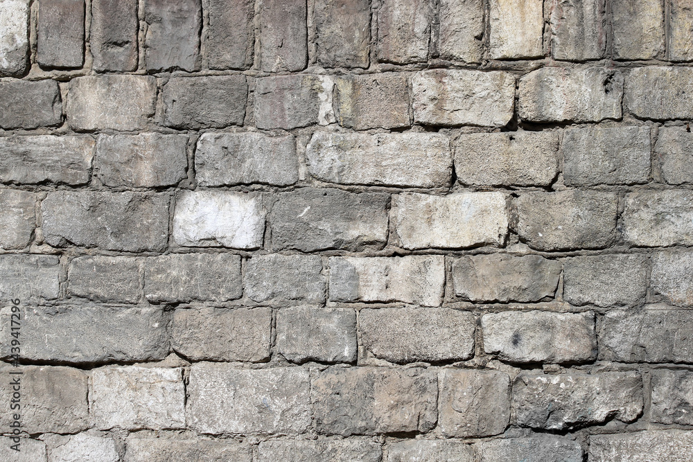 Fototapeta premium Old wall made of rough stone blocks as a background