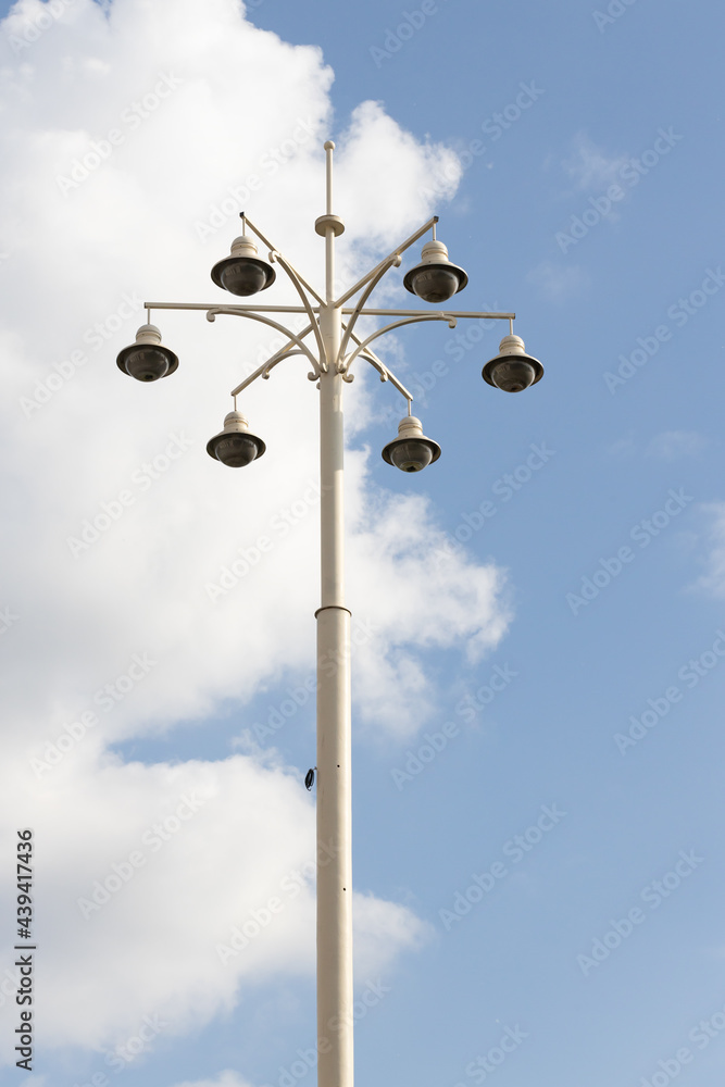 Street lamp with lamps in a classic style against a blue sky. High quality photo Street lamp with lamps in a classic style against a blue sky. High quality photo