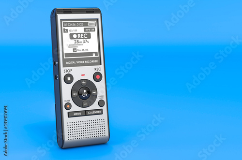 Modern digital voice recorder, dictaphone on blue backdrop, 3D rendering photo