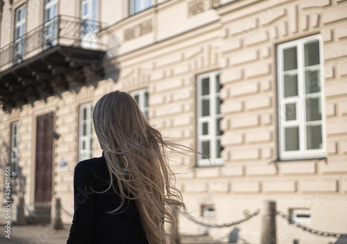 blonde girl seen from behind with her hair flowing in the wind © konrad hryciuk