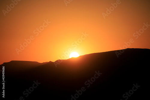 Colorful sunset over a desert mountain landscape © Benjamin