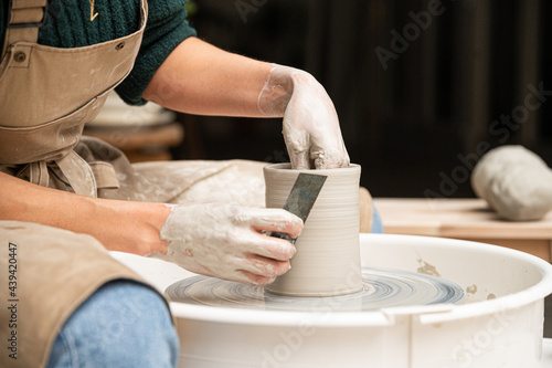 Close up of ceramist woman Making Clay Product With Pottery lathe in her studio photo