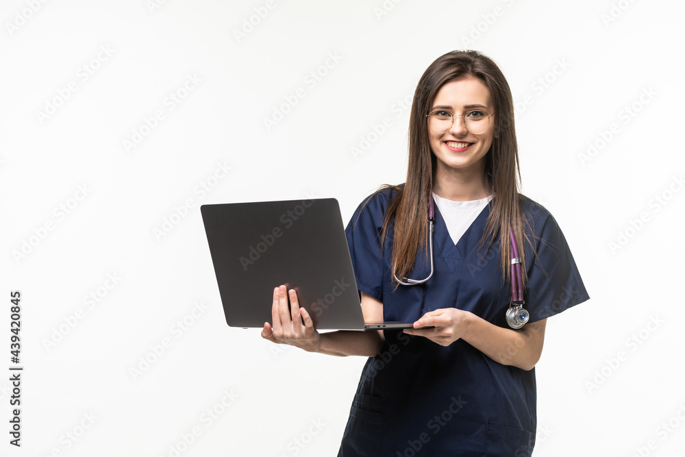 Young female doctor with laptop on grey background Young female doctor with laptop on grey background