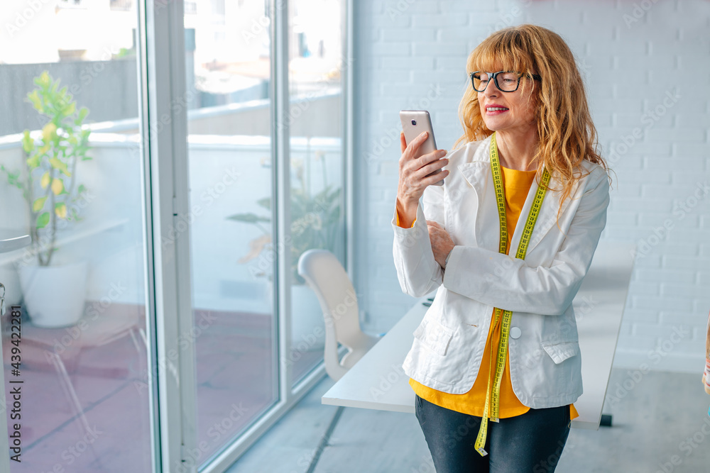 businesswoman in office with mobile phone businesswoman in office with mobile phone
