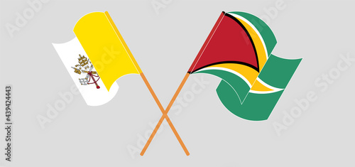 Crossed and waving flags of Vatican and Guyana