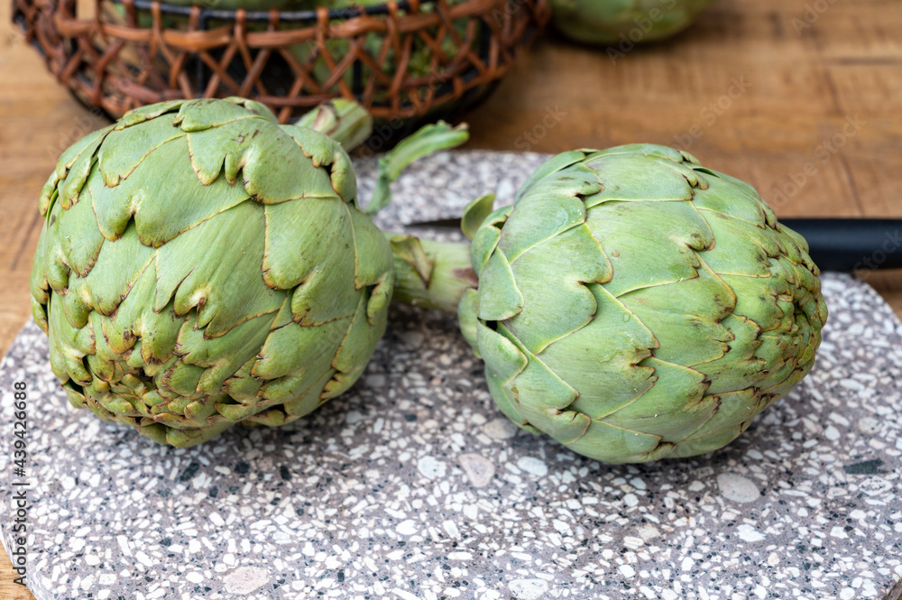 Fototapeta premium Fresh ripe green artichokes heads ready to cook