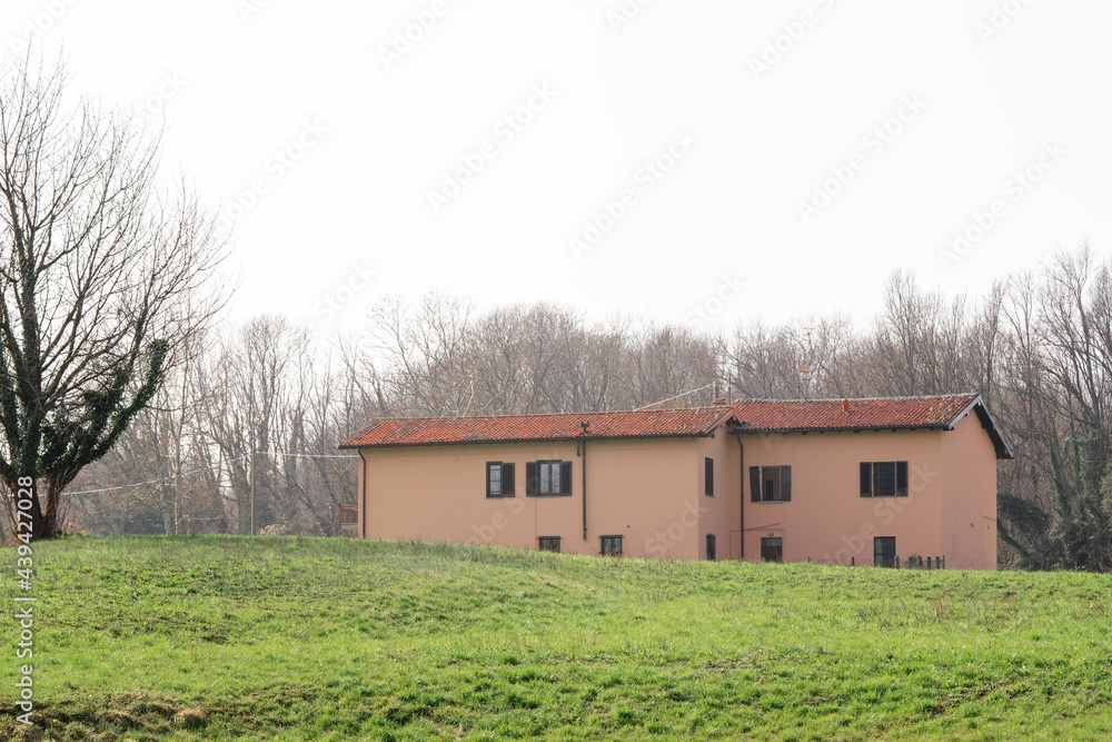 House on green meadow field hill in late spring. Como, Italy House on green meadow field hill in late spring. Como, Italy