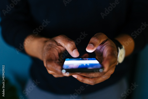 Anonymous black man using smartphone