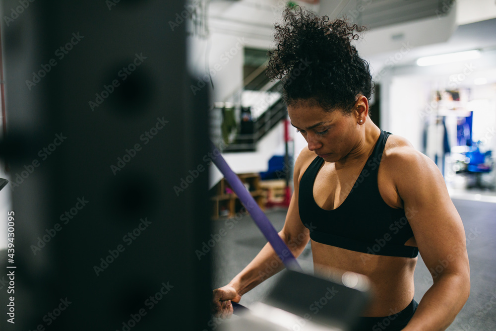 Muscular female athlete exercising with resistance band Muscular female athlete exercising with resistance band