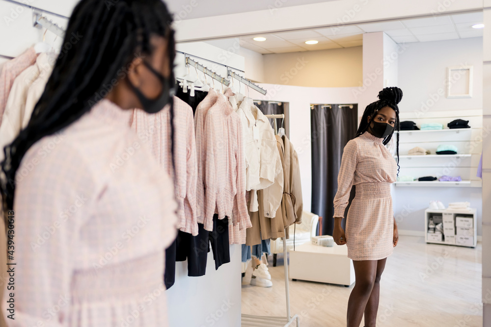 Woman during shopping in a dress shop Woman during shopping in a dress shop