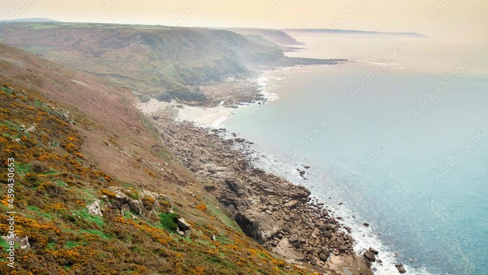 Beautiful scenic coastline with blue transparent waters and colorful grass in 4K. Cape Cornwall, Coast Path, Penzance, Land's End - old houses by the cliffs on a hill in England, United Kingdom. Beautiful scenic coastline with blue transparent waters and colorful grass in 4K. Cape Cornwall, Coast Path, Penzance, Land's End - old houses by the cliffs on a hill in England, United Kingdom.