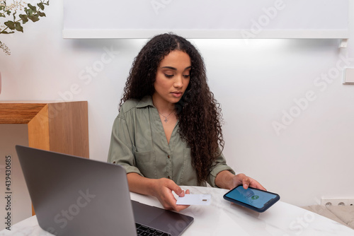 Black woman making online purchases photo