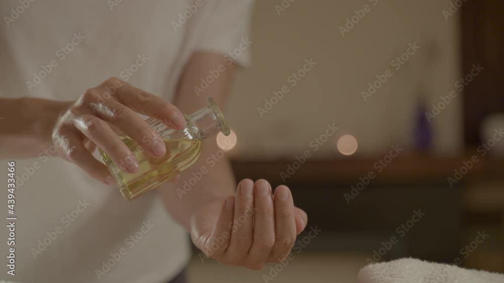 A Female physiotherapist massage with oil to another woman on the stomach A Female physiotherapist massage with oil to another woman on the stomach