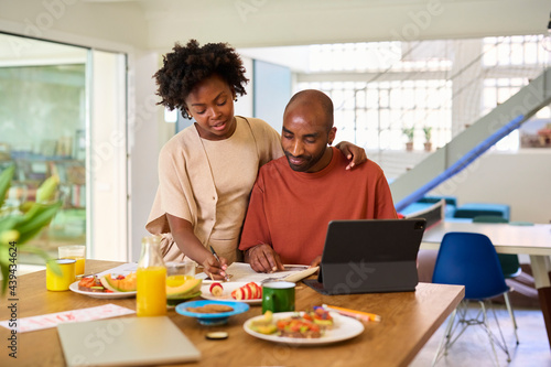 Woman and man reading newspaper.
