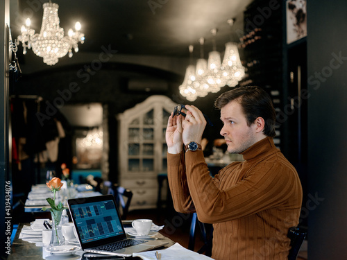 A man with a laptop in a cafe photo