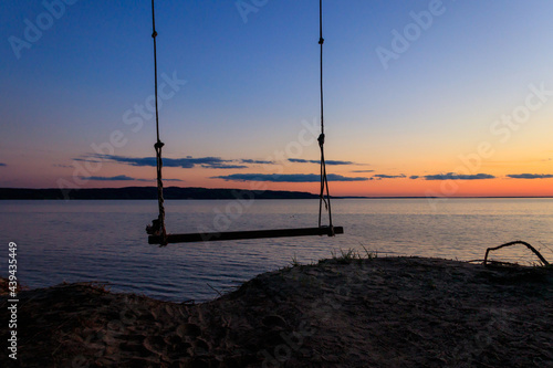 Rope swing on a shore of the Dnieper river in Ukraine at sunset