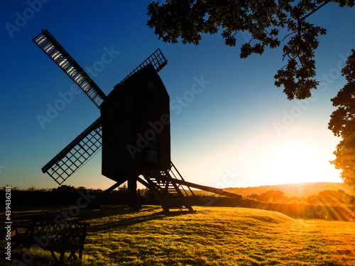 Old traditional windmill silhouette at sunset