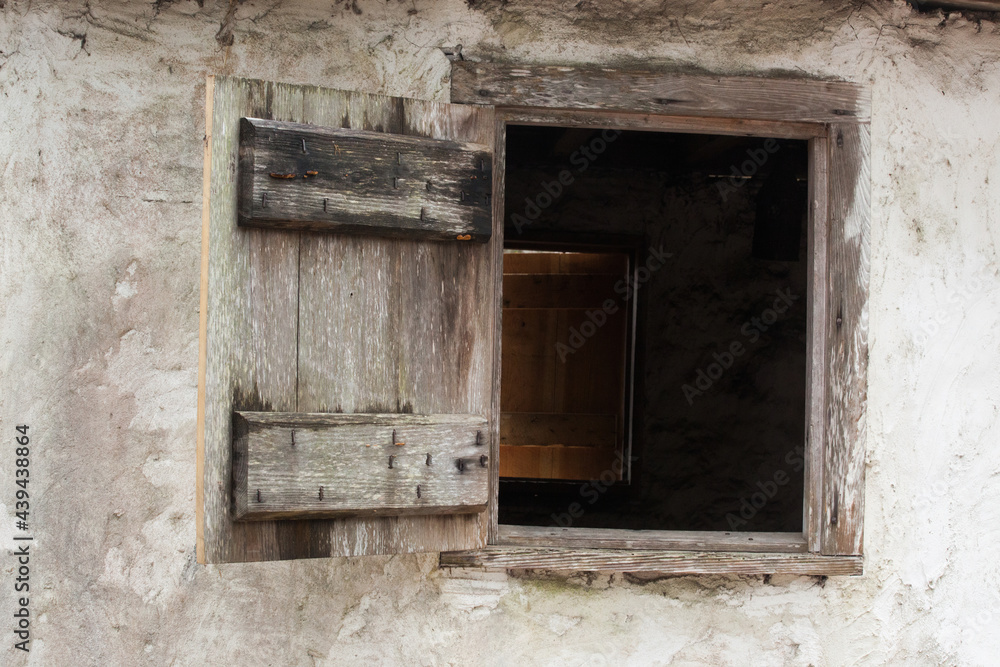An open wooden window in a building.