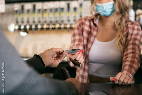 Brewery: Bartender Checks Identification Of Male Customer