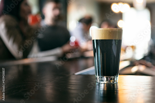 Brewery: Glass Of Rich Stout Beer On Bar photo