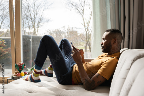 Man Using Phone On Couch