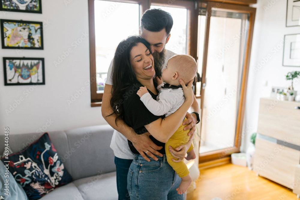 © Mihajlo Ckovric/Stocksy - Family lifestyle, young millennial parents spending free time with their baby
