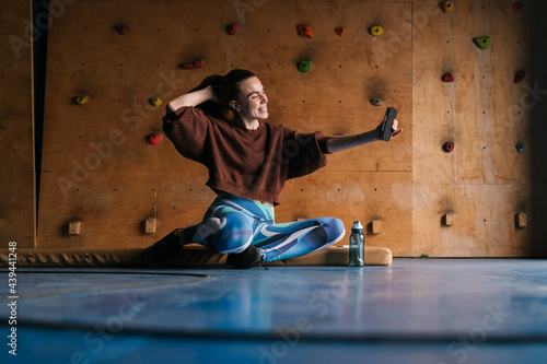 Cheerful female climber taking a selfie in a climbing centre photo