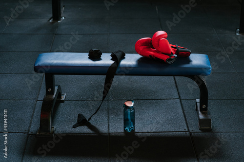 Boxing gloves and bandages on bench in modern gym photo