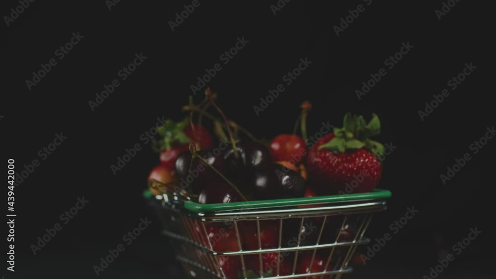 Red fresh strawberries and cherries in a little trolley from a super layout. Fruits in a little trolley Red fresh strawberries and cherries in a little trolley from a super layout. Fruits in a little trolley