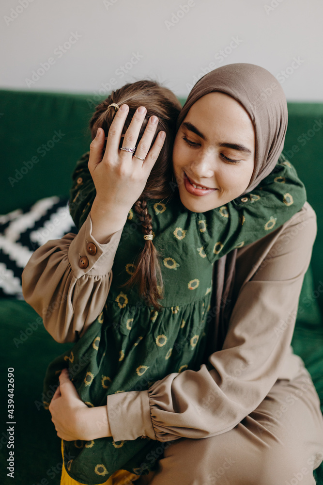 Happy Muslim woman hugging little kid Happy Muslim woman hugging little kid