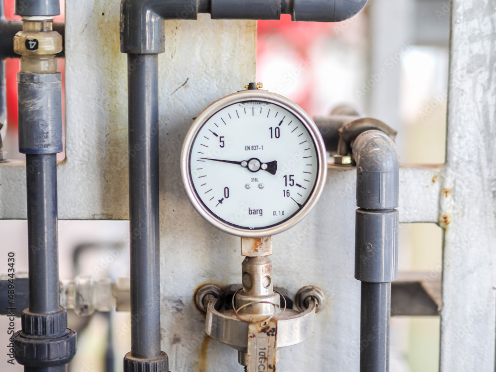 Pressure gauge of measuring instrument close up in industry zone at power plant with closed up Pressure gauge of measuring instrument close up in industry zone at power plant with closed up