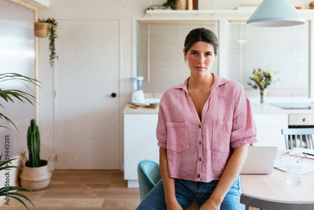 Young woman relaxing on kitchen table Young woman relaxing on kitchen table