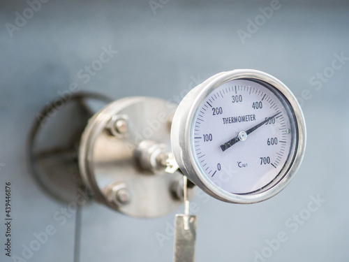 Temperature gauge for measuring instrument close up in industry zone at power plant.