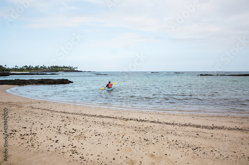 Man on kayak near beach in a tropical island, Hawaii