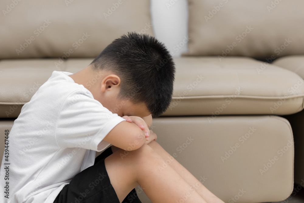 Asian child sitting alone with sad feeling, Concept for bullying, depression stress or frustration Asian child sitting alone with sad feeling, Concept for bullying, depression stress or frustration