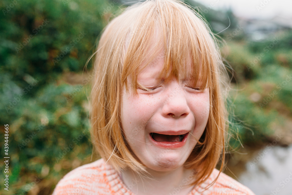 A cute little girl crying in nature A cute little girl crying in nature