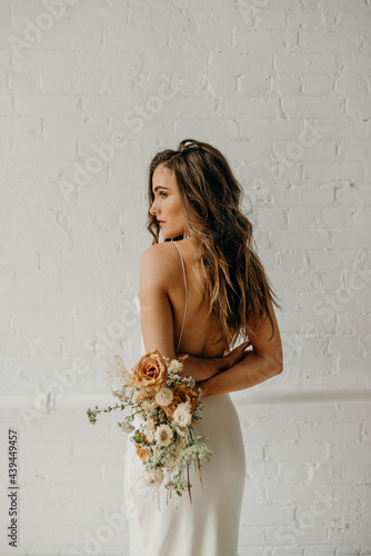 Young bride holding dried flower bouquet photo