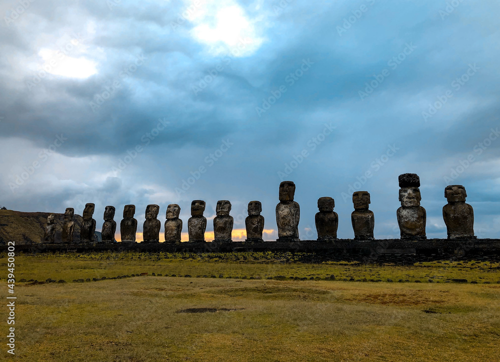 Easter Island's mysterious Moai statues lined up for the sunrise on a cloudy day