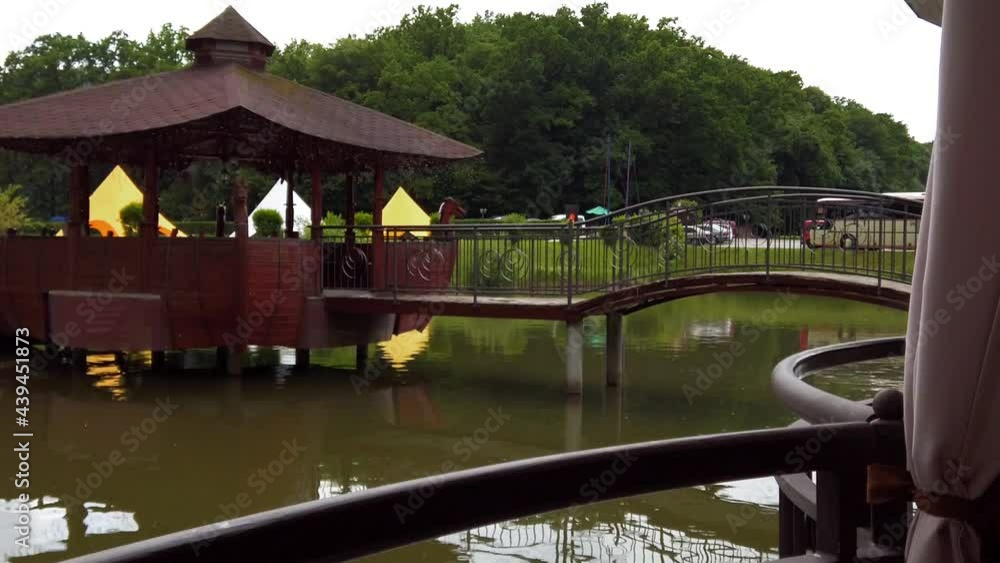 Restaurant on a forest lake. Wooden gazebo in the middle of the lake. Restaurant on a forest lake. Wooden gazebo in the middle of the lake.