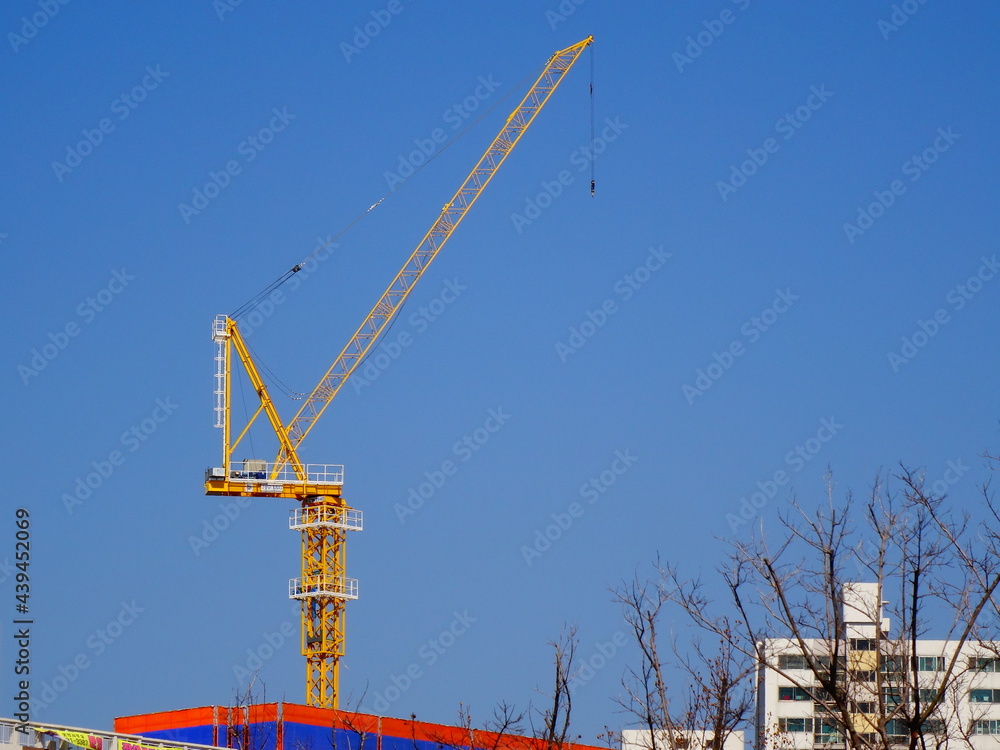 Blue sky and yellow construction crane