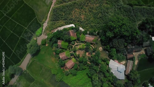 aerial view of an ecolodge on remote area with river and green vegetation