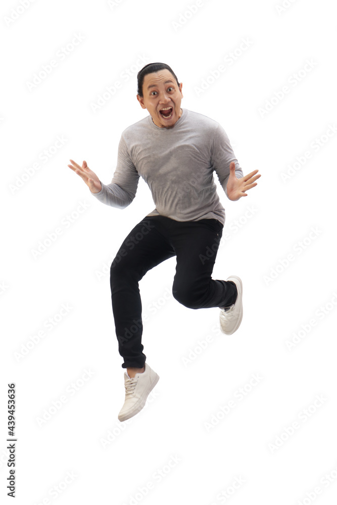 Asian man wearing grey shirt black denim and white shoes, jump while screaming shouting celebrating victory, winning gesture Asian man wearing grey shirt black denim and white shoes, jump while screaming shouting celebrating victory, winning gesture